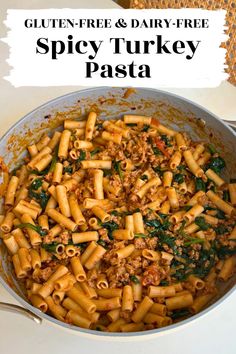 a pan filled with pasta and spinach covered in sauce