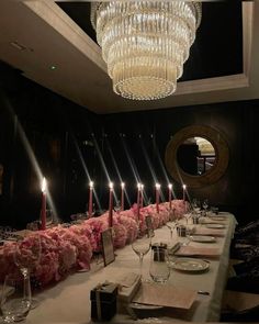 the long table is set with candles and place settings