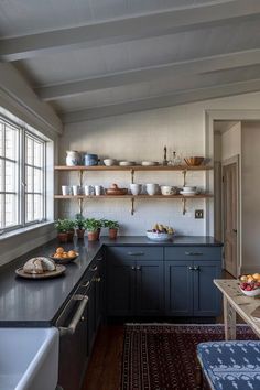 the kitchen is clean and ready to be used for cooking or baking, with dishes on the shelves