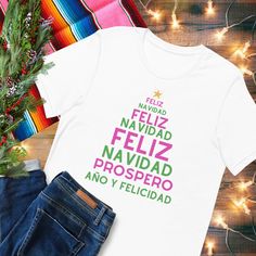 Feliz navidad y prospero año T-Shirt.  This classic unisex jersey short sleeve tee fits like a well-loved favorite. Soft cotton and quality print make users fall in love with it over and over again. These t-shirts have-ribbed knit collars to bolster shaping. The shoulders have taping for better fit over time. Dual side seams hold the garment's shape for longer. New Year Gift Crew Neck T-shirt, White Christmas T-shirt With Text Print, New Year Crew Neck T-shirt With Letter Print, New Year Graphic Print Short Sleeve T-shirt, New Year White Short Sleeve Tops, White Short Sleeve T-shirt For New Year, Christmas T-shirt With Text Print For Gifting, Christmas Short Sleeve T-shirt With Text Print, Christmas Gift T-shirt With Text Print