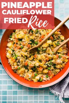 pineapple cauliflower fried rice in a red bowl with wooden spoons on the side