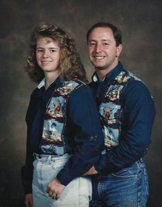 a man and woman are posing for a photo in their cowboy outfits, smiling at the camera