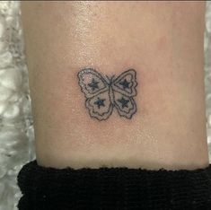 a small butterfly tattoo on the ankle