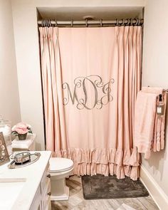 a monogrammed shower curtain in a bathroom