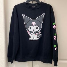 Sanrio Kuromi Print Crew Neck Black Sweatshirt Brand New Without Tags. Celebrate My Melody's Rival And Friend With This Kuromi Cute And Lightweight Sweatshirt. Long Sleeve Ribbed Crew Neck Sweatshirt 60% Cotton, 40% Polyester Print Art On Front And Sleeve Relaxed Fit Imported Harajuku Style Black Top With Cartoon Print, Kawaii Black Top For Streetwear, Black Kawaii Top For Streetwear, Black Harajuku Style Graphic Sweatshirt, Black Harajuku Style Sweatshirt With Graphic Print, Black Harajuku Style Crew Neck Top, Cute Black Top For Streetwear, Cute Black Tops For Streetwear, Kawaii Black Sweatshirt With Graphic Print