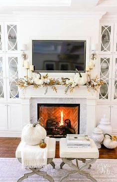 a living room filled with furniture and a flat screen tv mounted above a fire place