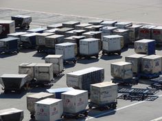 many boxes are stacked on top of each other in the middle of an airport tarmac