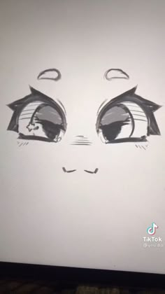 a drawing of a face with eyes drawn on the side of a computer monitor screen