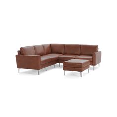 a brown leather sectional sofa sitting on top of a white floor