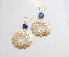 These gorgeous earrings feature faceted cushion cut cobalt blue glass stones with matte gold textured filigree pendants dangling beneath. The gold filigree pendants are light weight, beautifully detailed. Ear wires are high quality gold plated French hook ear wires.Total length: approx. 2.2" (56mm)Filigree pedant: matte gold plated, 32mm acrossCobalt blue glass stone: 8 mmEar Wires: gold  plated over brass, High quality plated. Anti tarnishFor more beautiful modern earrings:http://www.etsy.com/s Elegant Blue Pierced Chandelier Earrings, Blue Nickel-free Elegant Chandelier Earrings, Elegant Blue Nickel-free Chandelier Earrings, Chandelier Earrings Gold, Gold Chandelier Earrings, Filigree Pendant, Gold Filigree, Bohemian Earrings, Earrings Blue