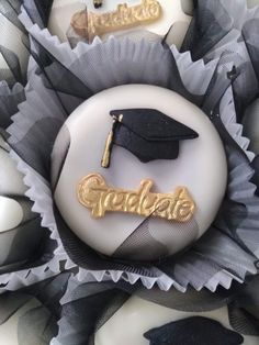 a graduation cap and tassel sitting on top of a cake