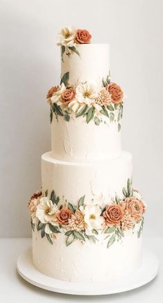 a three tiered wedding cake with flowers on it