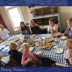 a group of people sitting around a table with plates of food in front of them