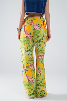 Length: Full length. Subcategory: Pants. Fit: Relaxed fit. Leg: Wide leg. Style: Party. Fabric: Lightweight woven fabric . Zipper: Zip side. runs true to size. S. 100% Polyester LINING 100% Polyester Tropical Stretch Bottoms With Floral Print, Stretch Tropical Bottoms With Floral Print, Spring Tropical Pants With Elastic Waistband, Tropical Style Pants With Elastic Waistband For Spring, Tropical Stretch Floral Print Bottoms, Tropical Bottoms With Elastic Waistband, Tropical Long Pants With Elastic Waistband, Tropical Wide Leg Green Pants, Yellow Floral Print Vacation Pants