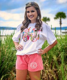 Our personalized graphic tees are so cute and make great personalized gifts! We are loving this tropical flower monogram design. Perfect for summer! Pair with jeans, our monogrammed shorts, or monogrammed leggings! The options are endless!  GILDAN Short Sleeve - 6.0 oz. pre-shrunk 100% cotton Long Sleeve - 6.0 oz. pre-shrunk 100% cotton V-Neck - 4.5 oz. pre-shrunk 100% ring spun cotton Tank Top - 5.3 oz. pre-shrunk 100% cotton Sweatshirt - 8 oz pre-shrunk 50% cotton/50% polyester   BELLA CANVAS Monogrammed Leggings, Flower Graphic Tee, Flower Monogram, Fall Football, Monogram Shirts, Beach Birthday, Black Friday Christmas, Tropical Flower, Flower Graphic