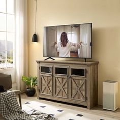 a woman is watching tv in the living room