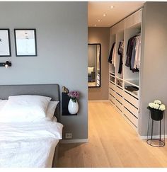 a white bed sitting next to a walk in closet