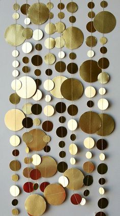 some gold and white circles hanging from strings