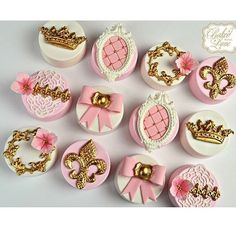 the cupcakes are decorated with pink and gold icing, which include tiaras