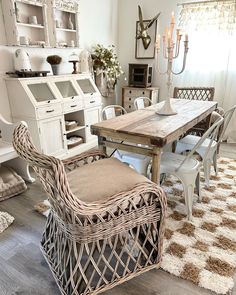 a dining room table and chairs in front of a hutch