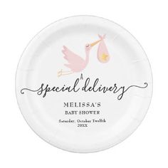 a paper plate with a stork design on the front and baby shower written in pink