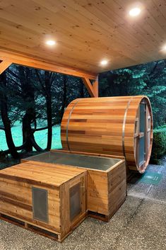 an outdoor sauna is shown in front of some trees