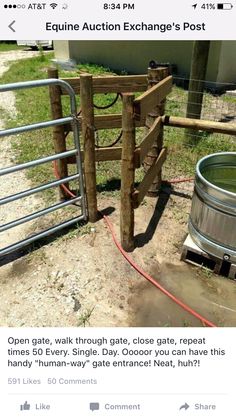 a wooden gate is next to a metal barrel