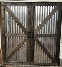 two wooden doors with metal slats on them