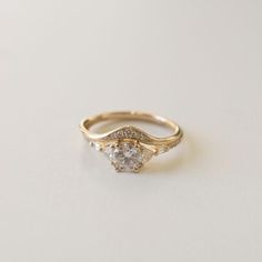 a yellow gold ring with two diamonds on it