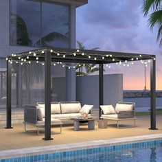 an outdoor living area next to a swimming pool with lights strung up on the pergol