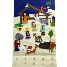 a felt nativity scene is displayed on a white towel with blue background and numbers