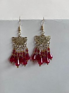 Red and gold dangly chandelier earrings Red Teardrop Chandelier Earrings, Red Teardrop Chandelier Earrings As Gift, Red Teardrop Chandelier Earrings With Ear Wire, Elegant Red Teardrop Beaded Earrings, Festive Costume Jewelry Dangle Earrings, Red Handmade Dangle Earrings, Red Handmade Dangle Danglers, Red Bohemian Chandelier Earrings For Pierced Ears, Red Bohemian Chandelier Earrings