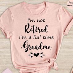 a pink shirt that says i'm not retired, i'm a full time grandma