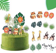 a cake topper with jungle animals and giraffes on it, surrounded by palm leaves