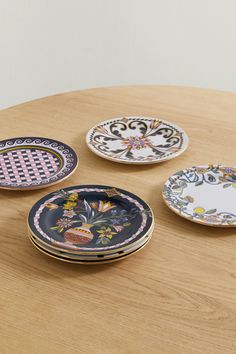 four plates sitting on top of a wooden table