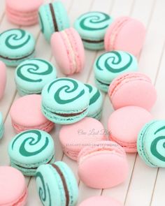 pink and blue macaroons with swirl designs on them