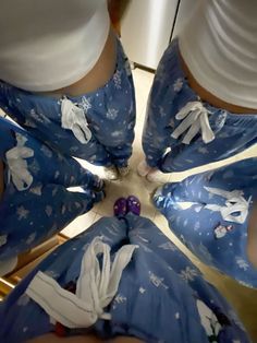 several people wearing blue and white outfits standing in a circle