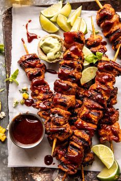 chicken skewers with lime wedges and ketchup