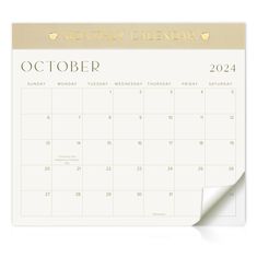 a white calendar with gold foil on it