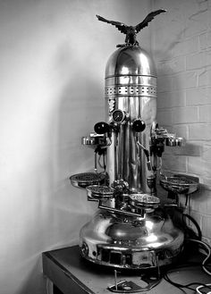 an old fashioned coffee maker on top of a table