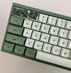 a green and white computer keyboard with letters on it