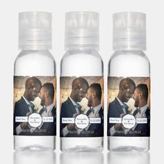 three clear bottles filled with wedding photos and labels on the front one has an image of a bride and groom kissing each other