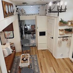 the interior of a tiny apartment with wood floors and white walls, is decorated in neutral tones