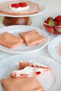 there are three plates with food on them and one has strawberries in the background