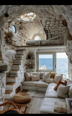 a living room filled with furniture and stone walls