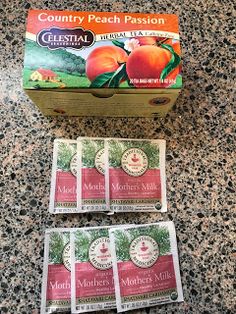 four packets of peach tea sitting on top of a counter next to an open box