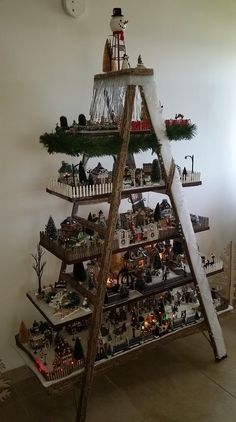 a christmas tree made out of wooden ladders and other decorations on top of it