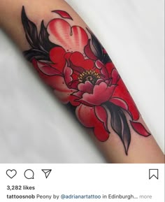 a red flower tattoo on the arm