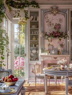 a dining room table and chairs in front of a window with flowers on the wall