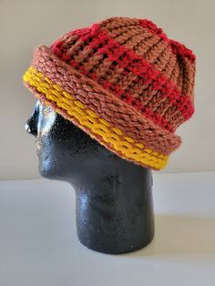 a knitted hat is on top of a mannequin's head,